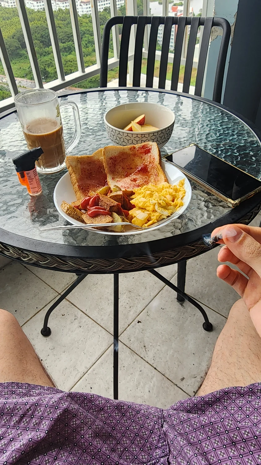 A real family breakfast with eggs, toast, fruit and coffee on a sunny terrace